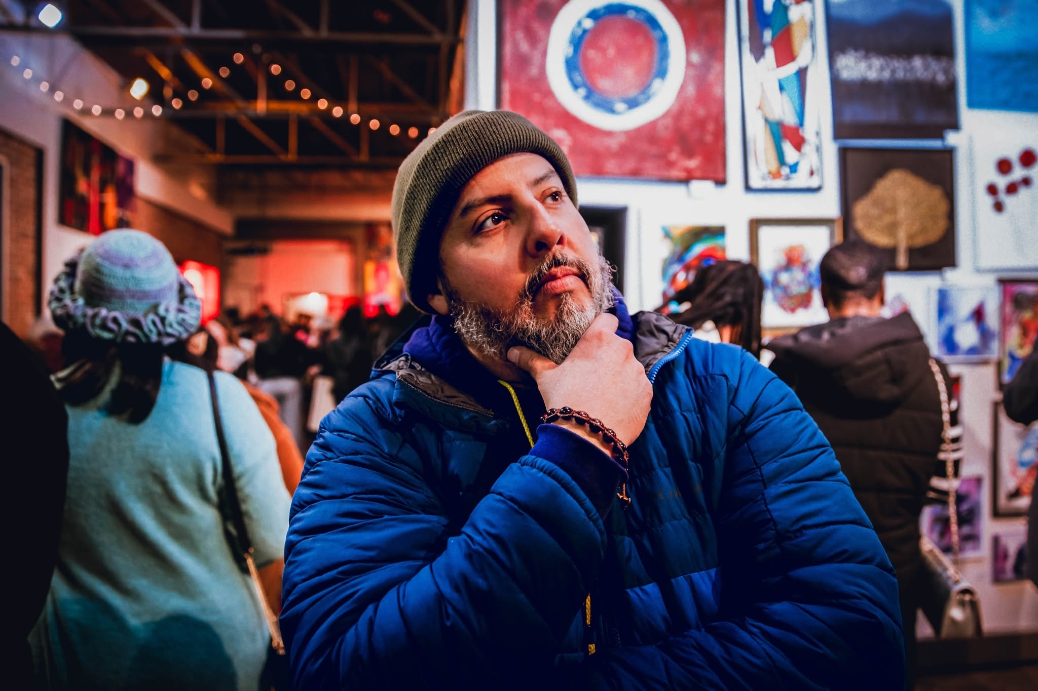Danilo G. Santos at an art gallery, thoughtful pose